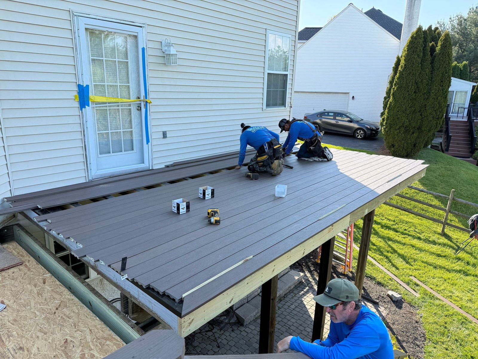 Brown composite deck with diagonal board pattern beside a flagstone patio walkway near the Main Line, PA