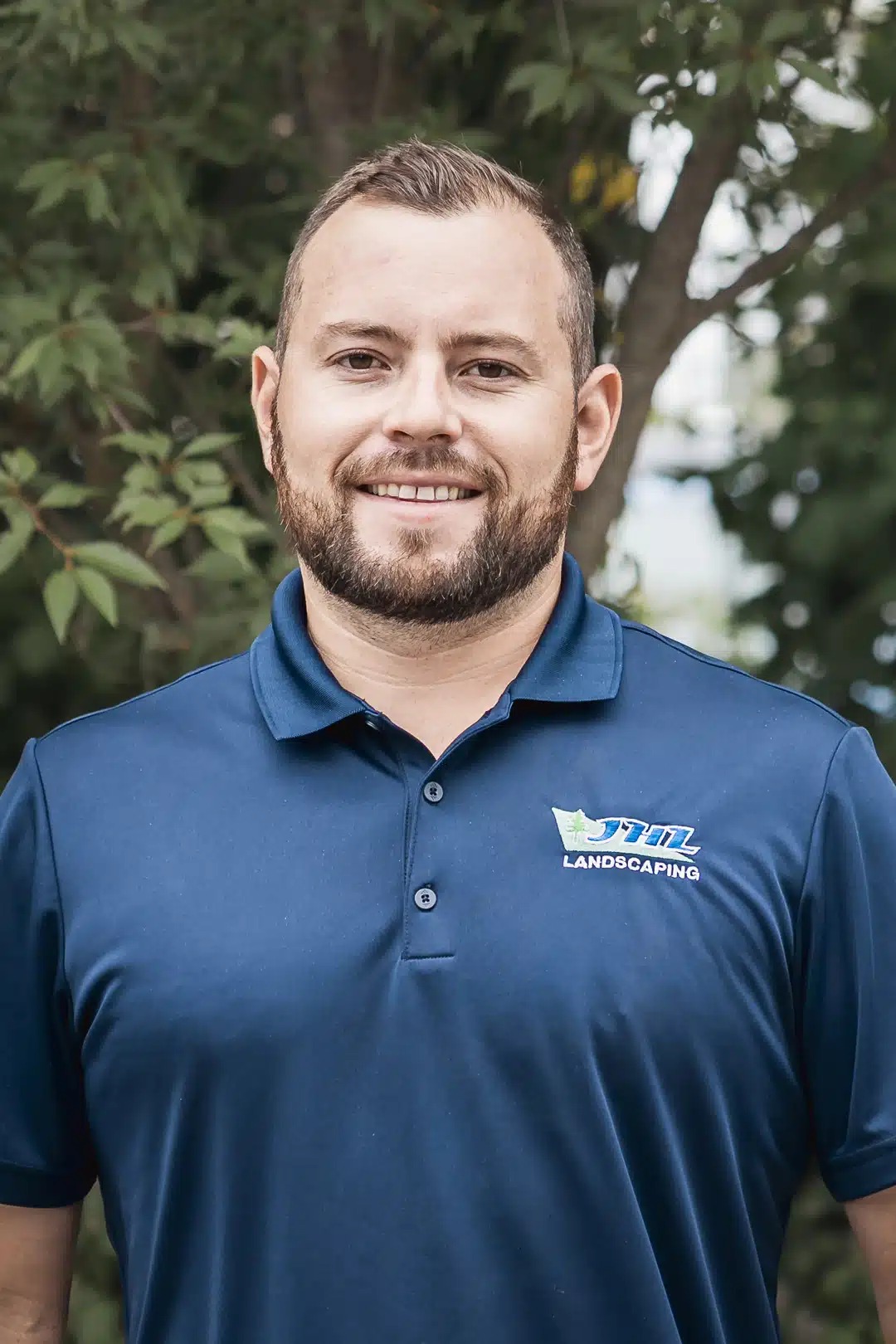Sean Arrell, Operations Manager at JHL Deck Builders, in a navy JHL polo